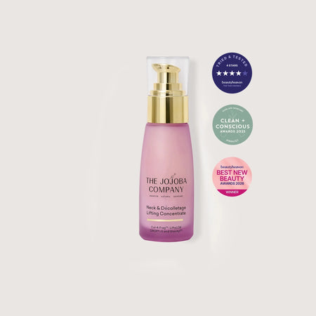 Pink neck serum skincare bottle with gold cap on a white background, featuring The Jojoba Company branding and awards.