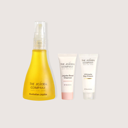 Three skincare products from The Jojoba Company on a light gray background