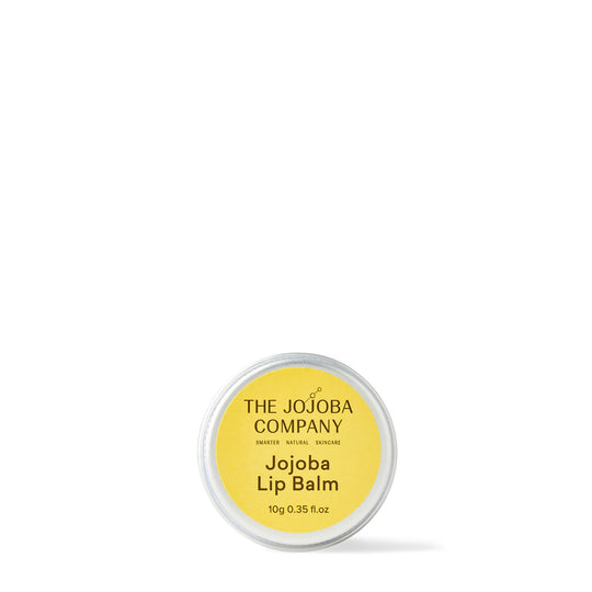 A container of The Jojoba Company Jojoba Lip Balm against a white background.