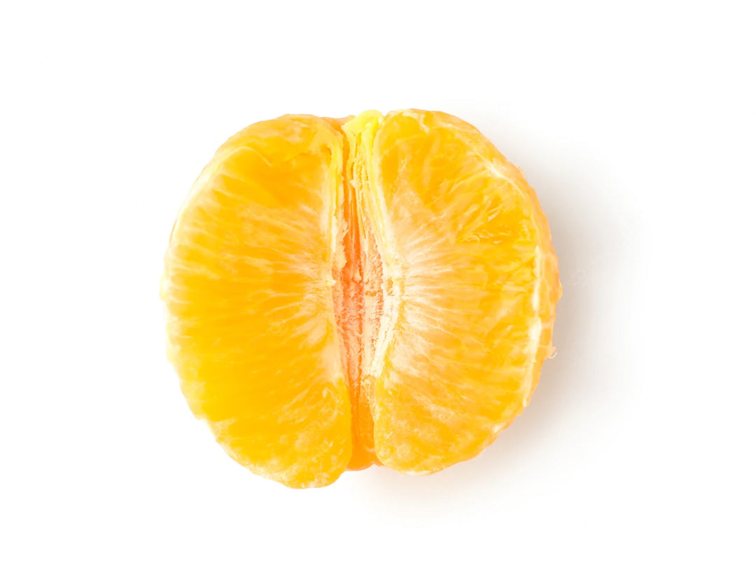 A peeled orange half on a white background.