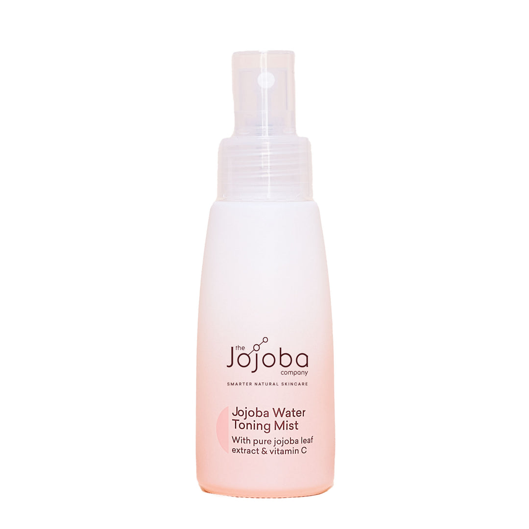 A spray bottle of Jojoba Water Toning Mist against a beige background.