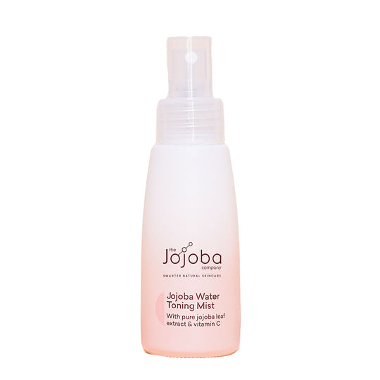 A spray bottle of Jojoba Water Toning Mist against a beige background.